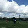 Campers going through fielding drill in the outfield on a cloudy day